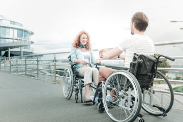 For you. Relaxed handicapped people looking at each other while spending time together outdoors