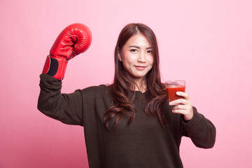 Young Asian woman with tomato juice and boxing glove.