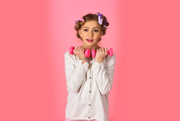 sport, morning exercise, weight lifting, pink background.