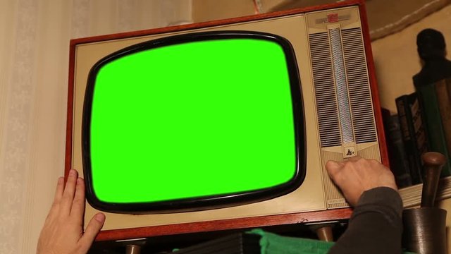 Old TV with green screen, retro TV in an old interior with a green screen