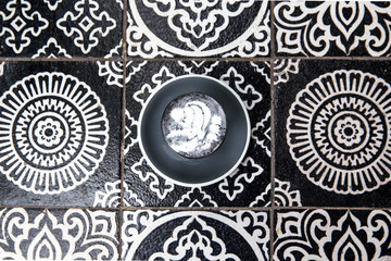 Charcoal latte on art floor as background.