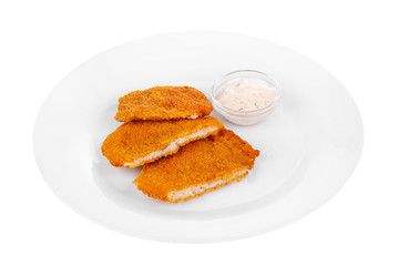 Schnitzel is cut into pieces of chicken, pork, meat, grilled, barbecue, on plate isolated white background. Tartar, sour cream, mayonnaise, white sauce. For the menu in the restaurant, bar. Side view