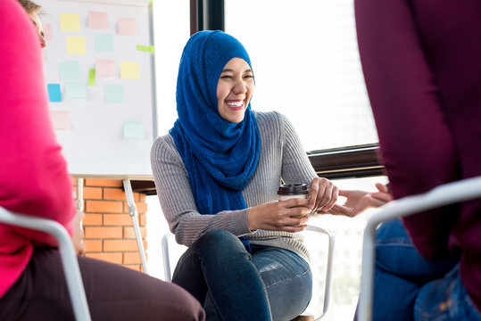 Happy Young Muslim Woman In Group Meeting