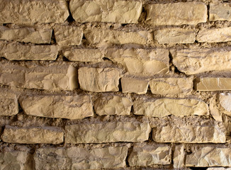 Texture of an ancient brick wall made of sandstone. Archaeological excavations. Abstract background for design.