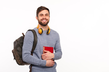 Cheerful male student with backpack - obrazy, fototapety, plakaty