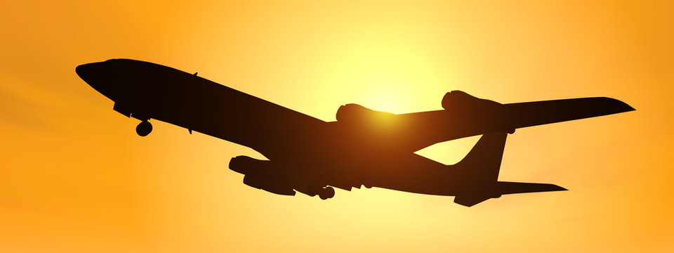 Silhouette eines Verkehrsflugzeuges vor gelbem Himmel