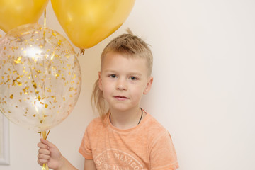 little boy with balloons white and gold color