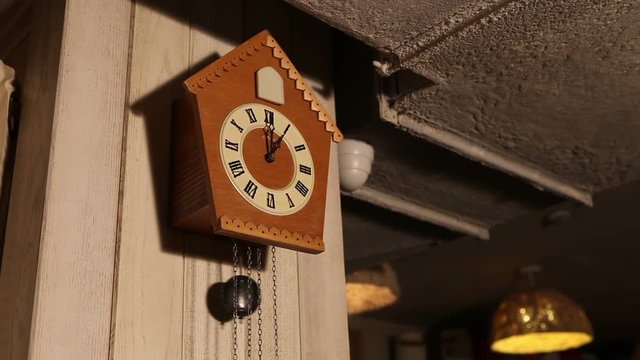 Old cuckoo clocks hanging on the camp in the room