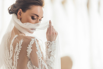 Stylish bride in lace dress in wedding salon - obrazy, fototapety, plakaty
