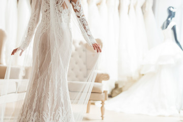 Cropped view of bride in lace dress in wedding salon - obrazy, fototapety, plakaty