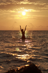 Beautiful Woman in the Sea Waves and Enjoying Sunshine with Open Arms