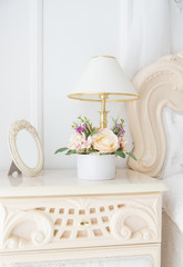 Bedside table with lamp and empty photograph frame