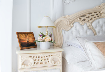 Flowers and photograph on bedside table
