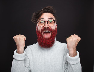 Excited trendy man with glittering beard