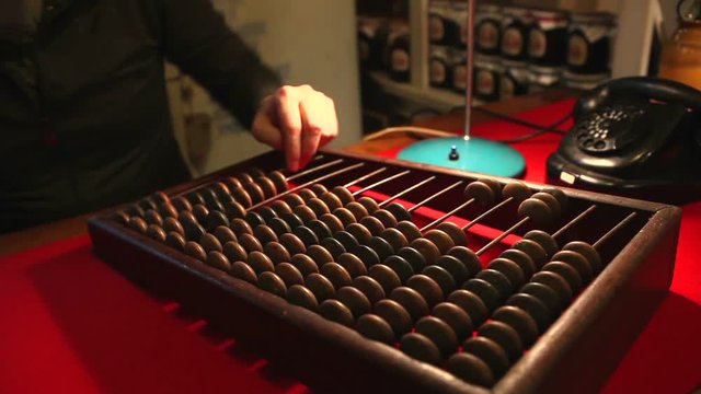 Man calling the old phone, wooden abacus in the office