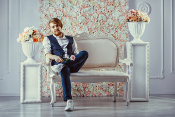 Bearded macho man, caucasian hipster with moustache holds pink rose.