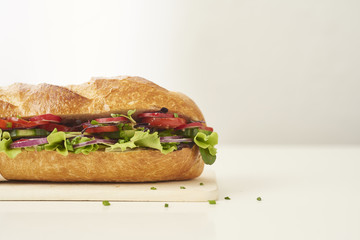 close up of fresh sandwich on plate of wood