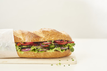 close up of fresh sandwich on plate of wood