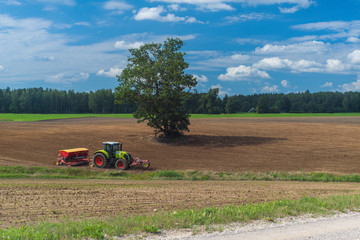 A plowed field and a road.