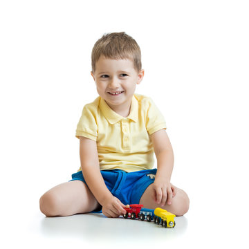Little boy playing with toy isolated on white