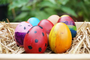 Conceptual colorful fancy easter eggs in wooden box