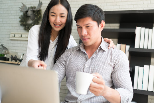 business co worker man and woman smile happy to online shopping working with laptop and box package in home office, clear tone process style
