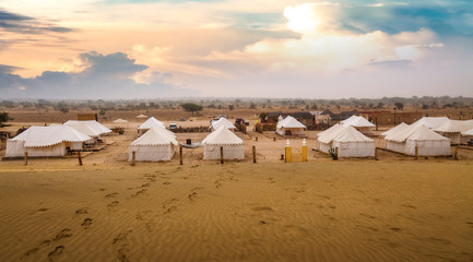 Desert sunset at Thar Jaisalmer Rajasthan with view of tourist tents used on desert safari © Roop Dey
