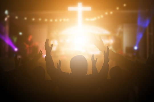Christians raising their hands in praise and worship at a night music concert. Eucharist Therapy Bless God Helping Repent Catholic Easter Lent Mind Pray. Christian concept background.