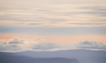 very soft light form of the peaks of mountains and clouds. Lines of repeating natural. Iceland. Relax the view.
