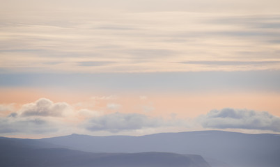 very soft light form of the peaks of mountains and clouds. Lines of repeating natural. Iceland. Relax the view.
