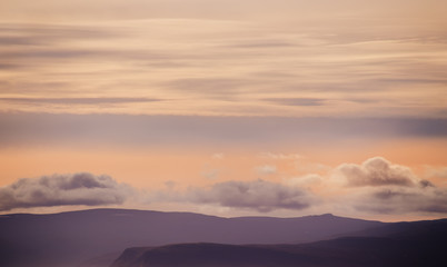 Silhouettes of mountains and clouds in the sky, Iceland landscape. Beautiful sunset light.
