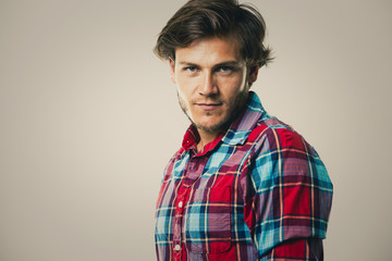 Fototapeta premium caucasian man wearing checkered shirt and trendy hairstyle