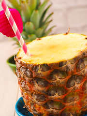 Fresh pineapple with a drinking straw