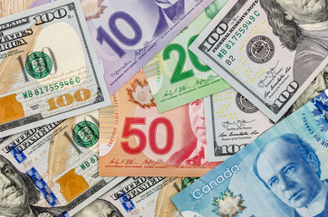 Fototapeta na wymiar canadian and american dollar as background