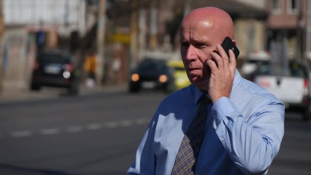 Satisfied Businessman Smiling and Talking to Mobile Downtown Street View.