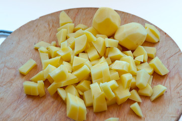 Cut potatoes into slices. Cut raw potatoes for soup. Cut fresh potatoes for cooking.