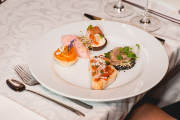 Served table for food and wine tasting. Snacks with shrimp, fish fillets, Spain tapas recipe food pintxos