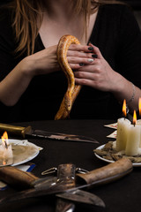 the snake descends from the witch's hands
