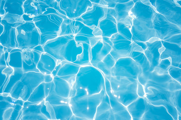 Fototapeta na wymiar Beautiful ripple wave and blue water surface in swimming pool