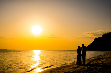 wedding couple in beautiful at sunset by the sea.