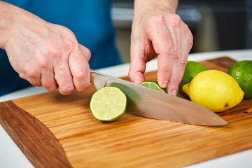 Man slicing limes