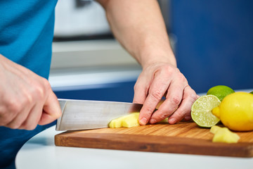 Man chopping fresh ginger