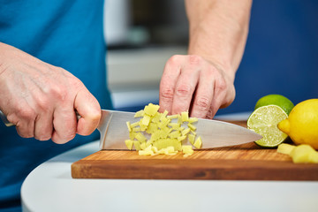Man chopping fresh ginger