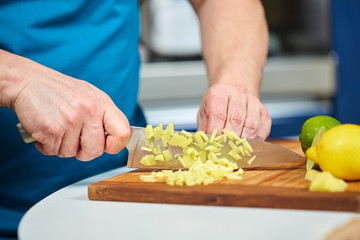 Man chopping fresh ginger