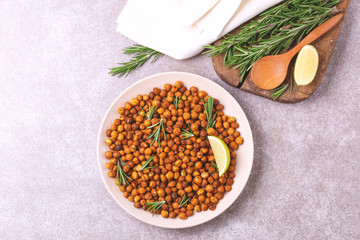 Fototapeta na wymiar Indian cuisine. Roasted chickpeas with lime and rosemary