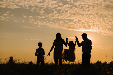 Family on sunset background