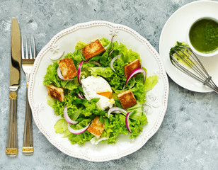 Spring salad with poached egg and crispy croutons. View from above.