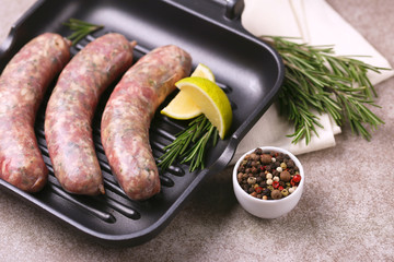 Raw homemade sausages with rosemary and lime