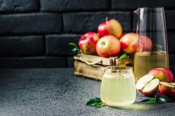 Apple cinnamon ginger kombucha and fresh apples in wooden box on concrete background. Selective focus, space for text.