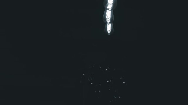 burning retro light bulbs on black background